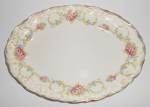 This is an offering for a rarely seen early Poxon/Vernon platter measuring 11-7/8" by 8-5/8".<BR><BR>The brightly colored floral pattern is highlighted with gold around the rim.<BR><BR>Ink m...