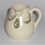This is an offering for a 3-1/2" high Roseville Medallion creamer.  <BR><BR>There is a pinhead size glaze flake on the spout and very light glaze crazing.<BR><BR>Shipping for this fine addition t...