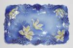 This is an offering for a Flow Blue 11-5/8'' by 7-1/2'' handled serving tray/platter with a lovely yellow floral with gold highlights pattern.<BR><BR>There is no mark.<BR><BR>There is a 4'' chip in on...