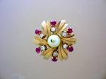 Beautiful Vintage Enhancer/Clip in 14K Gold with 6 5pt Diamonds 1 6mm Center Pearl and 6 10pt Rubies. There is a clip spring, so the piece could be worn as an enhancer for a necklace or chain, or on a...