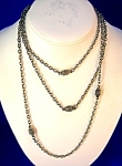 Silvertone Vintage Muff chain. The chain is  51 inches, and there are little coiled rope like acorns all along the links. The chain can be worn as a necklace, and can be made double or triple.