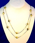 Double Goldtone chain with gold cubes. The necklace is pretty on, and is marked Korea on the round spring clasp. The necklaces are 25 inches.