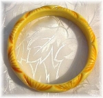 Light and darker yellow carved bangle bracelet purchased in England. simichrome test it comes off grey/yellow 1/2 inch wide 2 5/8 inches very pretty on the wrist. 