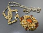 Gold Filigree W. Germany Dark and light Amber Crystals and small faux pearls marked on the back of the pendant letters reversed W German West Germany is on the clasp filigree and pearl chain 26 inches...