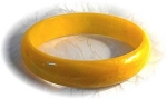 Golden yellow color Bakelite bangle bracelet 2 1/2 inches inner diameter  5/8 of an inch wide Bakelite has a  marbled look 