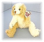 Ty Bean filled doggie called 'scruffry'His head turns, but his arms and legs are not jointed. He is 8 inches end to end, and has his paper label as well as his cloth label. 