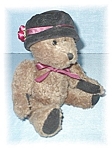 10 Inch Brown Teddy bear by BOYDS wearing a black velvet hat with burgundy roses on the side of the ribboned hat and a burgundy ribbon around her neck. She has her Boyds cloth label on her back, and s...