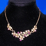 Vintage Gold 16 1/2 Coro Necklace with sprays of leaves, and different color crystals throughout the sprays. The necklace is in great vintage condition.