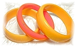 3 Bakelite Bangle bracelets 2 widest yellow ones 3/4 of an inch wide  middle one is 1/2 inch bright orange. The inner dimensions are 2 5/8 inches.