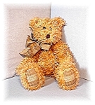 Lovely 19 Inch Boyd Pellet fill curly hair Teddy. His label says 1985-1994. He is in great condition, and has a tan plaid ribbon on, and his hands and feet are matching tan plaid also. 