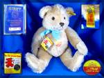 fully jointed STEIFF teddy bear with squeeker.  Stitched nose and mouth with felt paws. He has a STEIFF internationa Teddybear passport around his neck and the steiff button in his ear as well as the ...