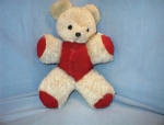 Vintage white mohair bear with a red corduroy outfit and red corduroy paws 12 1/2 inches tall 8 1/2 inches wide eyes are glass. 