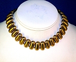 This Wonderful necklace is not signed. The metal is goldtone, and could be plate. It is 13 1/2 inches end to end, and 3/4 of an inch wide. It is in wonderful condition, and has a great kind of 'flexi'...