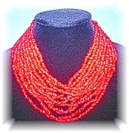 12 strands Dyed Coral/Glass 12 Strands beads graduated necklace the longest is 17 inches there is a goldtone petal cap. (I tried to show this in the picture)The clasp is a hook. 