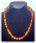 Baltic Golden Amber 22 inch necklace slightly Graduated necklace 10mm-13mm beads with an Amber barrel clasp the beads have leaves and bugs in them. 