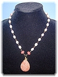 Designer necklace all hand wired with 22 Pink Freshwater pearls, and a large Pearshaped Sunstone pendant, with 2 Sunstones at the top of the drop. There is a goldtone toggle clasp at the end, and the ...