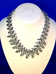  Vintage Rhodium Silvertone Choker Necklace that looks just like Hinged leaf fronds. The necklace is 17 1/2  inches from end to end. It is not marked, but looks to be from the 50s-60s. It is 1 1/4 inc...