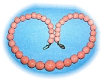 19 Inch vintage Pink Sponge Coral  bead necklace of Pale pink Coral. The largest bead is 3/4 of an inch and they graduate from there. There are stinning on