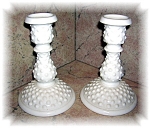 A nice pair of Fenton hobnail milk glass candle stick holders that measures about 6 inches tall and 4 inches across at the base.  They are in great condition and have the Fenton mark on the bottom (se...