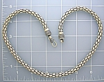 Beautiful and 66 grams heavy Sterling Silver chain. The chain is 20 inches end to end and 1/4 inch wide. There is a hook clasp, and it is designed to look like pebbles. It looks great with a larged pe...