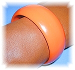 Tangerine Bakelite bangle bracelet inner diameter 2 1/2 inches and  slightly over 1 inch wide great with black .