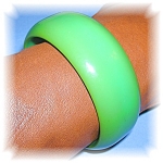 Stunning apple green bakelite bangle bracelet.  The inner diameter is 2 5/8 inches and the bracelet is slightly over 1 inch wide.  This looks stunning teamed with black and really makes a fashion stat...