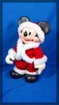 Mickey is all dressed up in his Santa Claus outfit trimmed in white.  He is poseable, legs move at the hip, arms at the shoulders, hands at the wrists, and his head turns, he is made of a hard rubber ...