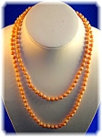 14K Gold Clasp and handknotted 5.6mm Pale Pink Coral Bead Necklace 36 Inches long and it looks great Doubled.