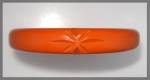 orange bakelite bangle bracelet with Carved Stars. The bracelet is pale orange and has a 2 1/2 inch inner Diameter and it is 1/2 inch wide. It does pass the Simichrome test.