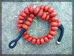 <BR>Red Coral Large bead necklace with a button Clasp. the necklace is 21 inches end to end and the coral is 3/4 of an inch long. It is Strung on black cotton