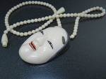 Bone Japanese Lady Face Necklace Signed 2 inches Long 2 1/4 inches wide 16 inch Beads twist clasp