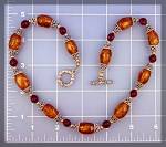 Necklace of Amber and Filigree Silver eith a Round Sterling Silver Toggle Clasp. The necklace is 18 Inches long and 1/2 inch wide