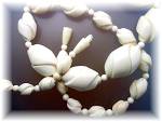 Antique Necklace pre Ban ivory Bone beads are Graduated 3/8 of an inch smallest to 1 inch. 22 inches long Hidden Twist Clasp beads carved into a Twist pattern. Grain in the ivory can be seen.