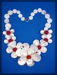 Beautiful and Handmade Flower By Norma of Hawaii Mother Of Pearl and Genuine Raised Coral Centers Necklace. The Necklace is 18 Inches with a 3 inch Center Flower and Coral Center. The Side Flowers are...