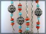 50 Inches large ornate silver beads probably low grade Silver and also Turquoise and Carnelian color Glass beads. The chain links are NOT Sterling looks good looped.