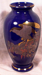 Very attractive oriental eagle decorates this substantial vase.  Stands 11 high and is 9 diameter at it's widest point.  Glaze is so high that it almost looks like cobalt glass.  Perfect for a showy d...