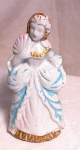 Vintage 4" Made in Japan Colonial woman with fan held to her face and wearing a most demure expression.  She is painted only on the front and has lost some of her color, perhaps due to too vigoro...