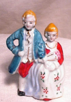 Small, yet nicely detailed colonial couple marked MADE IN OCCUPIED JAPAN.  He has presented her with a bouquet of flowers and she looks a bit unsure about the whole thing.  Tiny hand painted flowers d...
