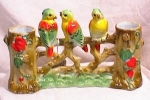Way cool family of three brightly colored parrots or parakeets perched on a limb between two hollow tree stumps.  The stumps on either side serve as the vases.  No chips or cracks in this vintage cera...