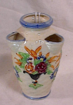 Attractive ceramic vase made in the Majolica style with a basket weave background and raised vases of flowers, but this one is marked Japan.  Hand painted and finished with a crackled type glazing.  W...