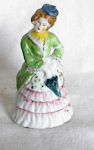Beautiful lady figurine in an elaborately decorated apron.  She has no chips or cracks and is  marked 