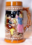This colorful mettlach-like stein shows a pair of beer drinking revelers on the front and a Germanesque wooded chalet scene on the reverse.  It is marked 