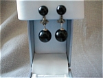 These wonderful black plastic dangle earrings are marked "Japan" on the clip.  Clip and mount is made out of silver which is tarnished to give it a more vintage look.  In excellent shape.