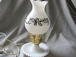 What a combination.  Milk glass ande Currier & Ives.  Wonderful hob nail base with a great Currier and Ives shade.  Lamp is 11" tall and in excellent condition.  Yes, it does work.