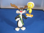 Cutest ornament with sylvester pretending to be a reindeer in order to get tweety.  From 1993.  In excellent condition, still in original box.