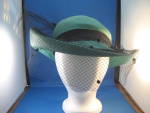 This would have looked great at the horse races.  Beautiful Adolfo II straw hat with net to cover the face and a black feather on the back.  Has "Adolfo II, New York, Paris" tag on the insid...