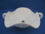 This is one of the unusual Fenton dishes.  Many of the hob nail milk glass will have one handle, but this one has two.  Is hard to find.  Dish is 5 1/2" in diameter and has the Fenton sticker sti...
