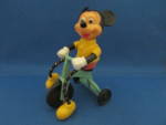 Wonderful toy from the 70s of Mickey Mouse riding a tricycle.  Toy is 4 1/2" tall and 3" long.  In excellent condition.