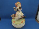 This cute music box if designed to look like the famous Hummel figurines, but were sold at Woolworths years ago.  Cute girl playing the flute and lamb looks as if it is dancing.  Music is the theme so...