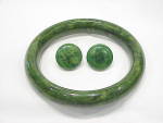 This is a vintage bakelite bangle bracelet and pierced earrings.  The bakelite is a dark marbled green color.  All of the pieces have been tested with Simichrome.  The bracelet measures 2-1/2 inches a...